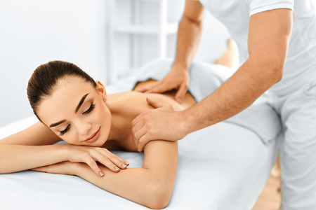 Photo of a man giving a lady a massage